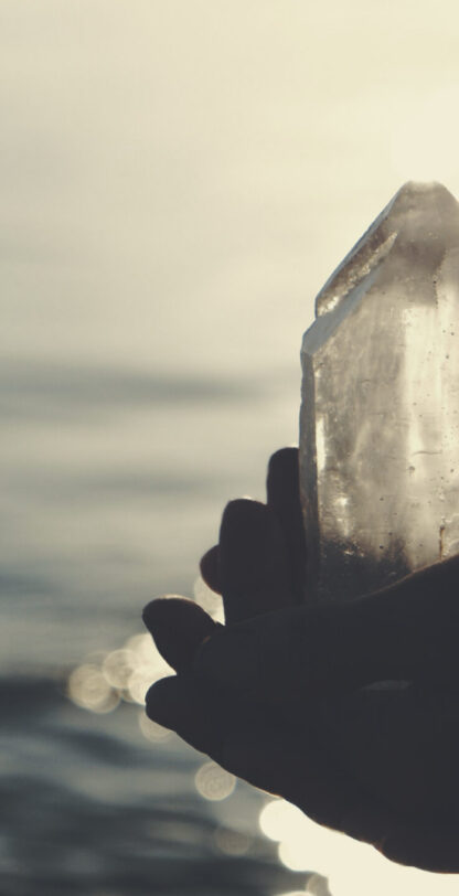 Man meditation at the beach. Crystal healing session